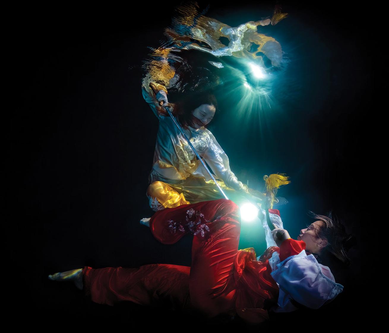 Two wushu athletes in the middle of an underwater