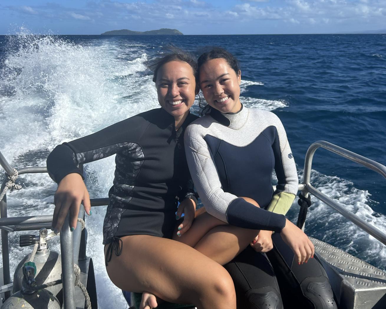 two women sitting on a dive boat