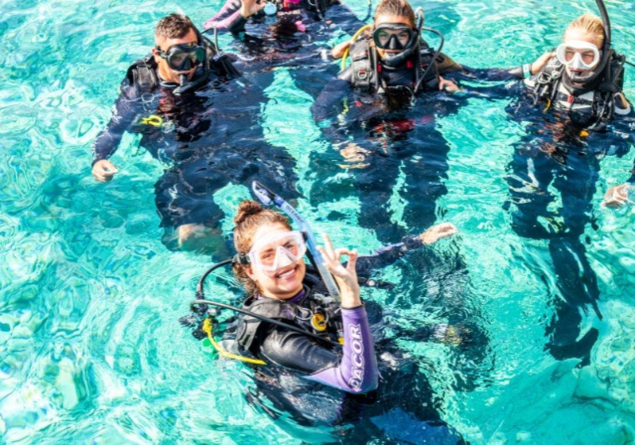 A group of people in scuba gear in water