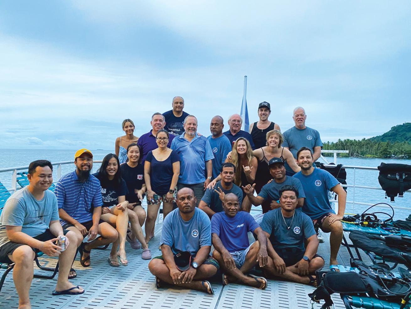 group of divers on the bow of a boat 