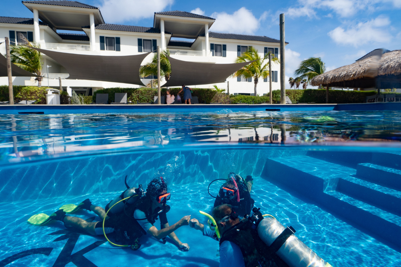 scuba divers in a pool