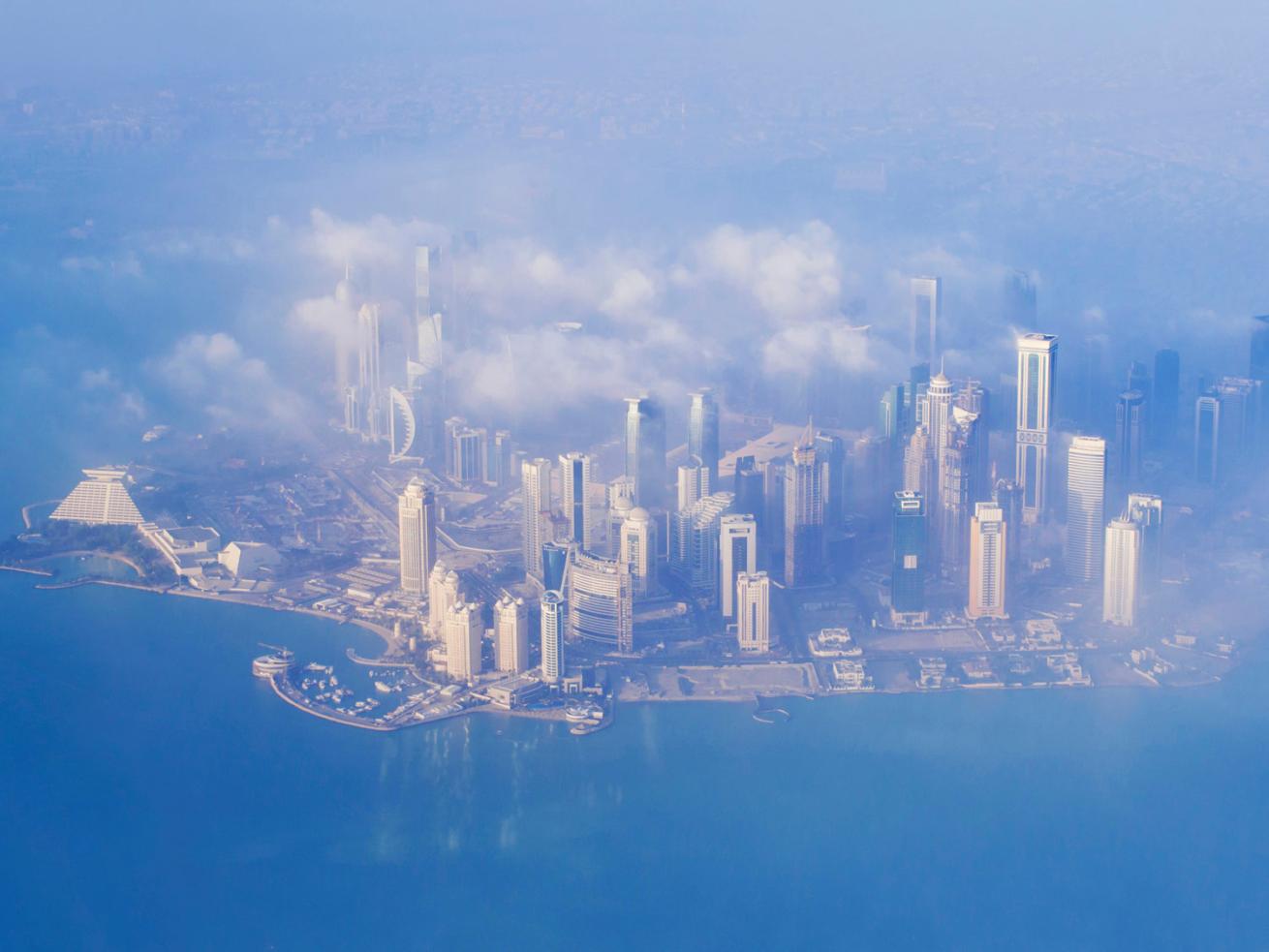 Doha from the plane as it appears to travelers in a foggy morning.