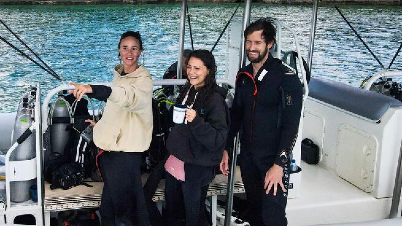 Three divers on a boat