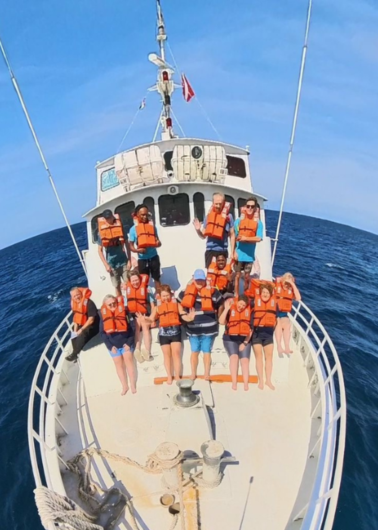 People practicing a safety drill on a boat