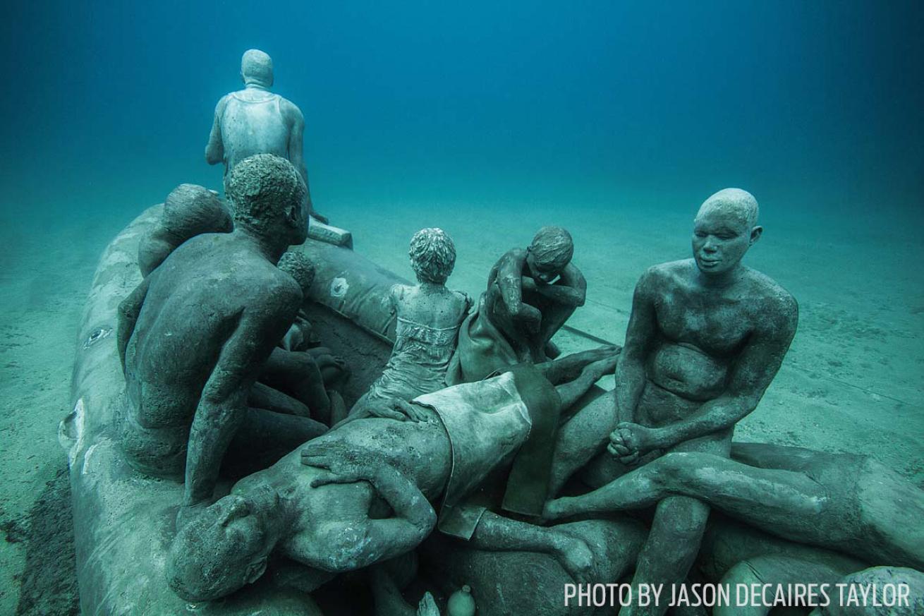 Raft of Lampedusa sculpture underwater