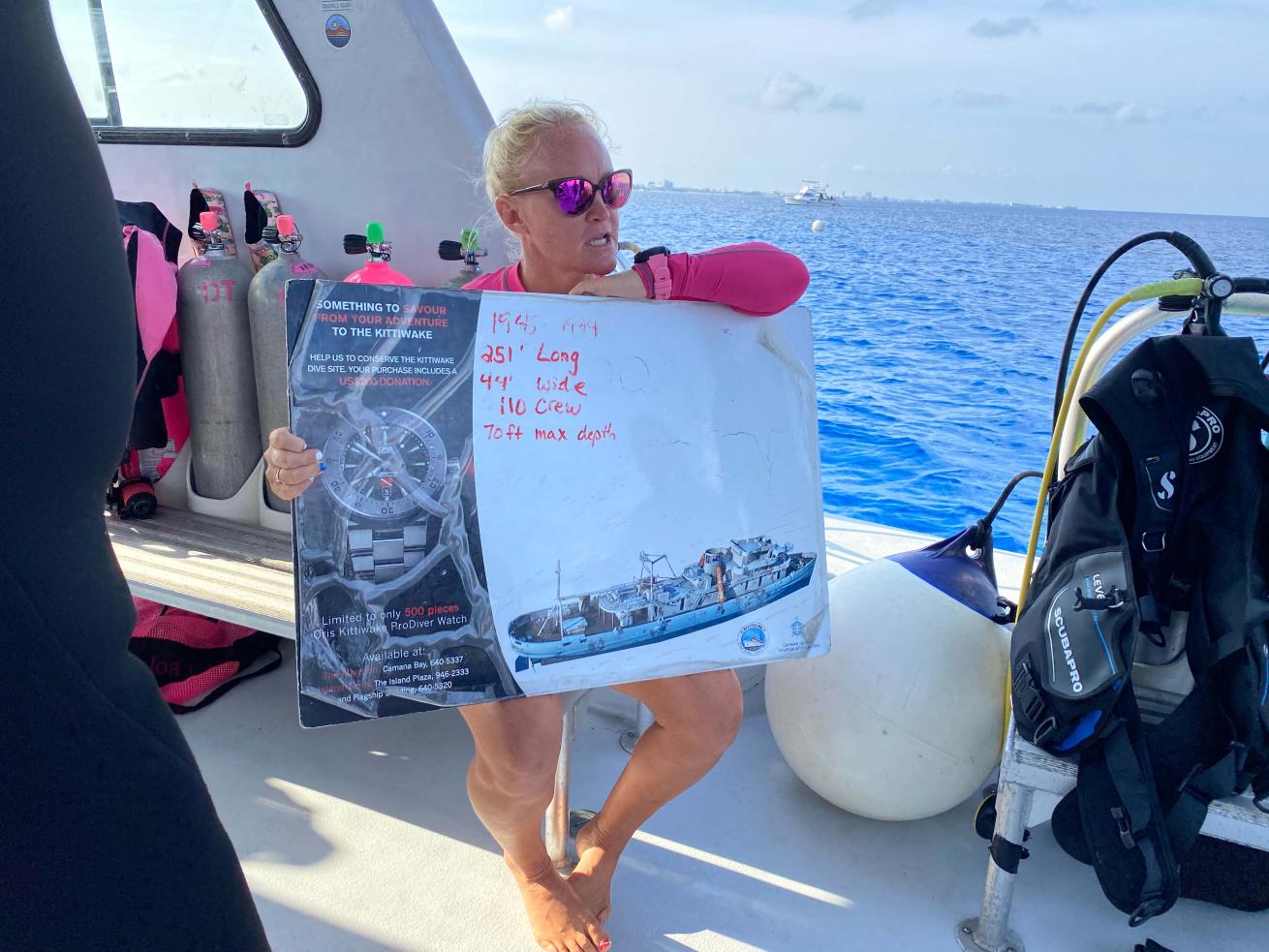 Jo Mikutowicz gives a dive briefing before enjoying one of Cayman's most famous dive sites, the Kittiwake wreck.