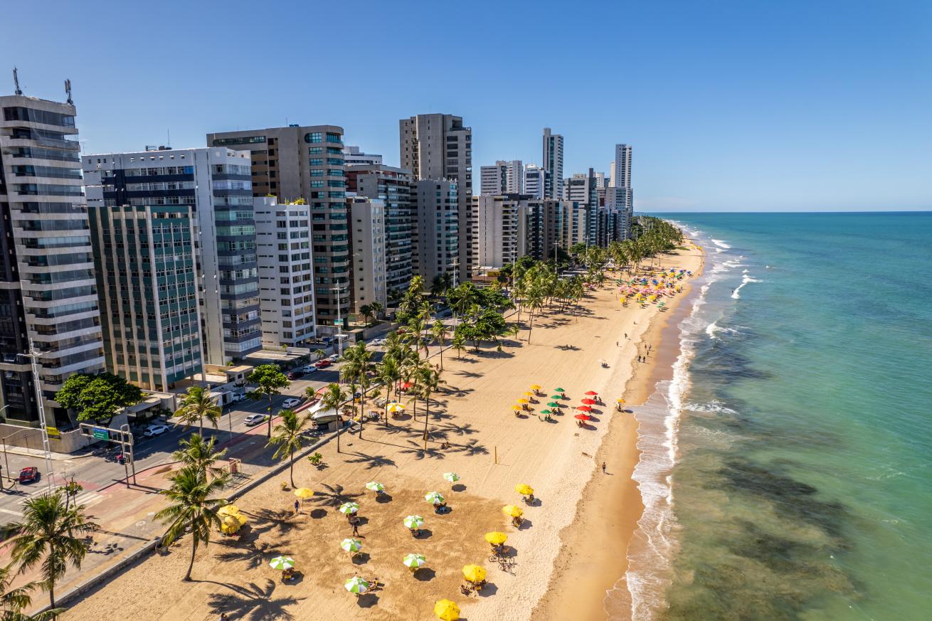 city buildings along a beach and clear water