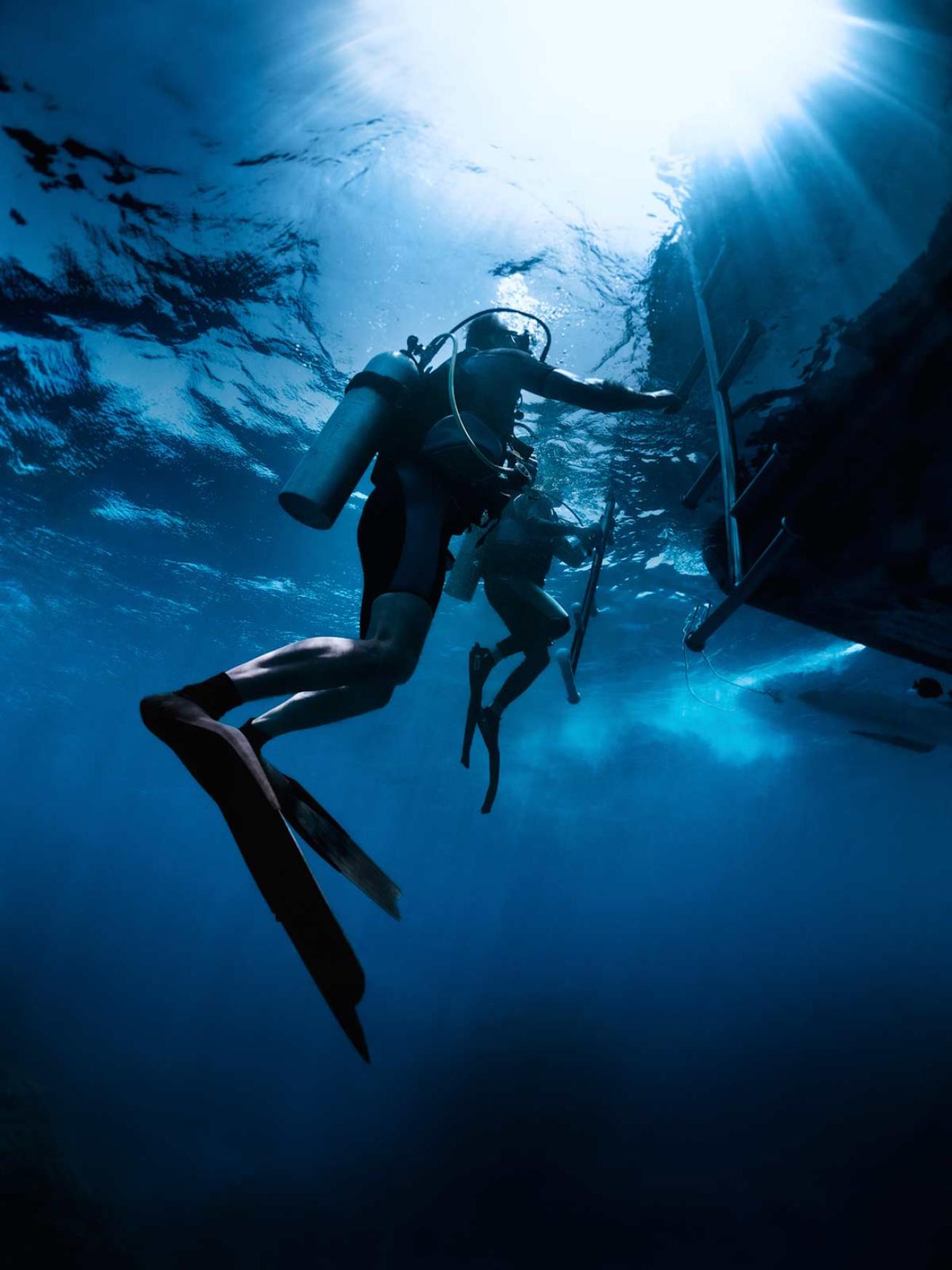 Scuba Diver Underwater Return to Boat Diving
