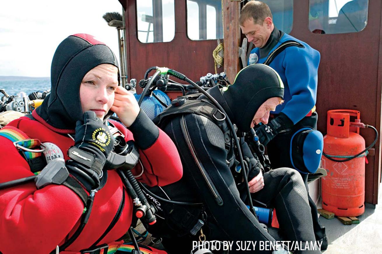drysuit scuba divers gear up for a dive