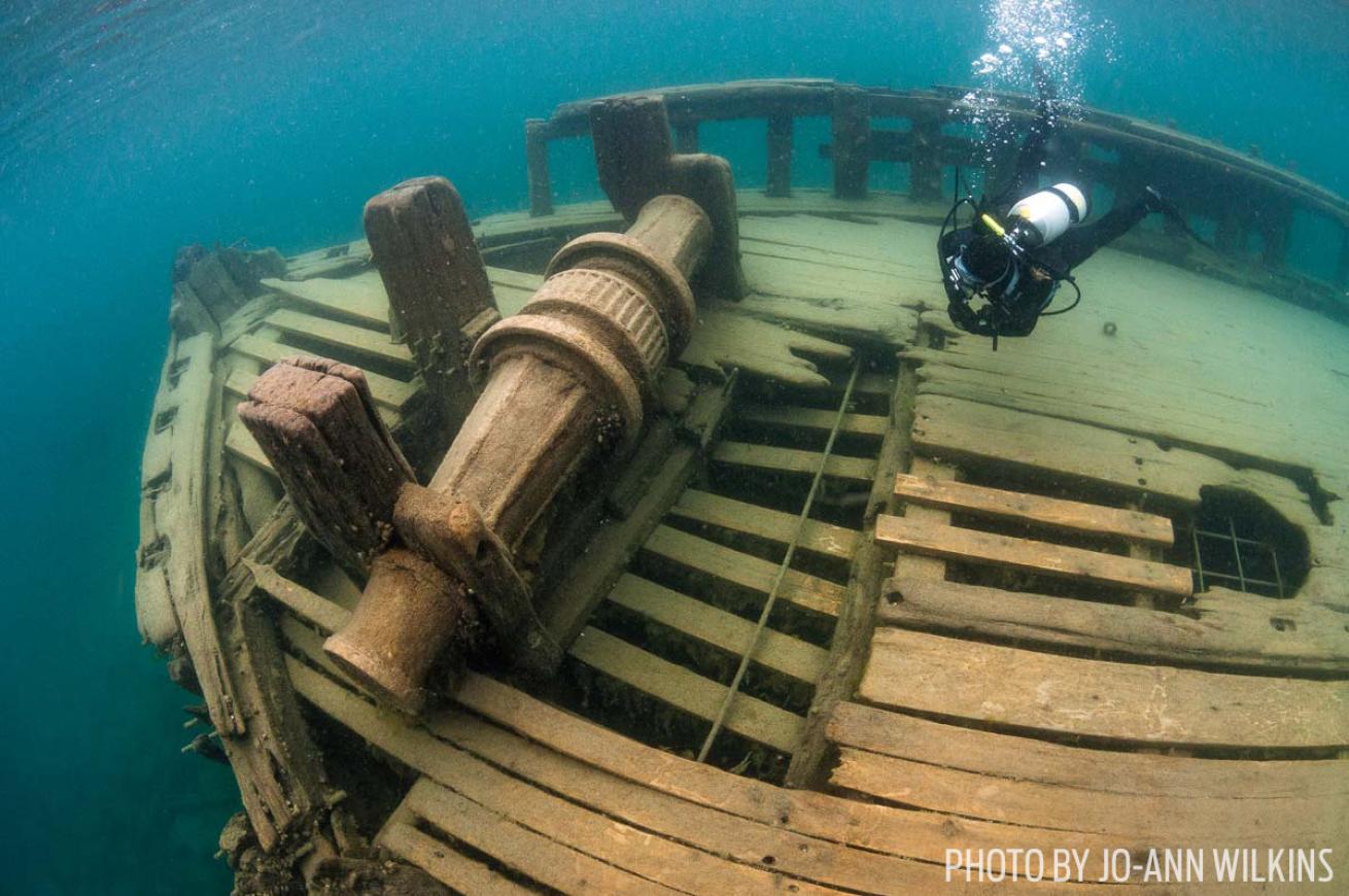 Scuba diver explores the wreck of the Sweepstakes in Ontario, Canada