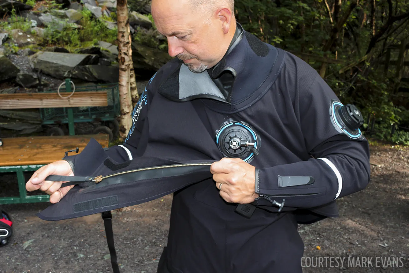 ScubaLab test diver puts on a Camaro drysuit during the gear test