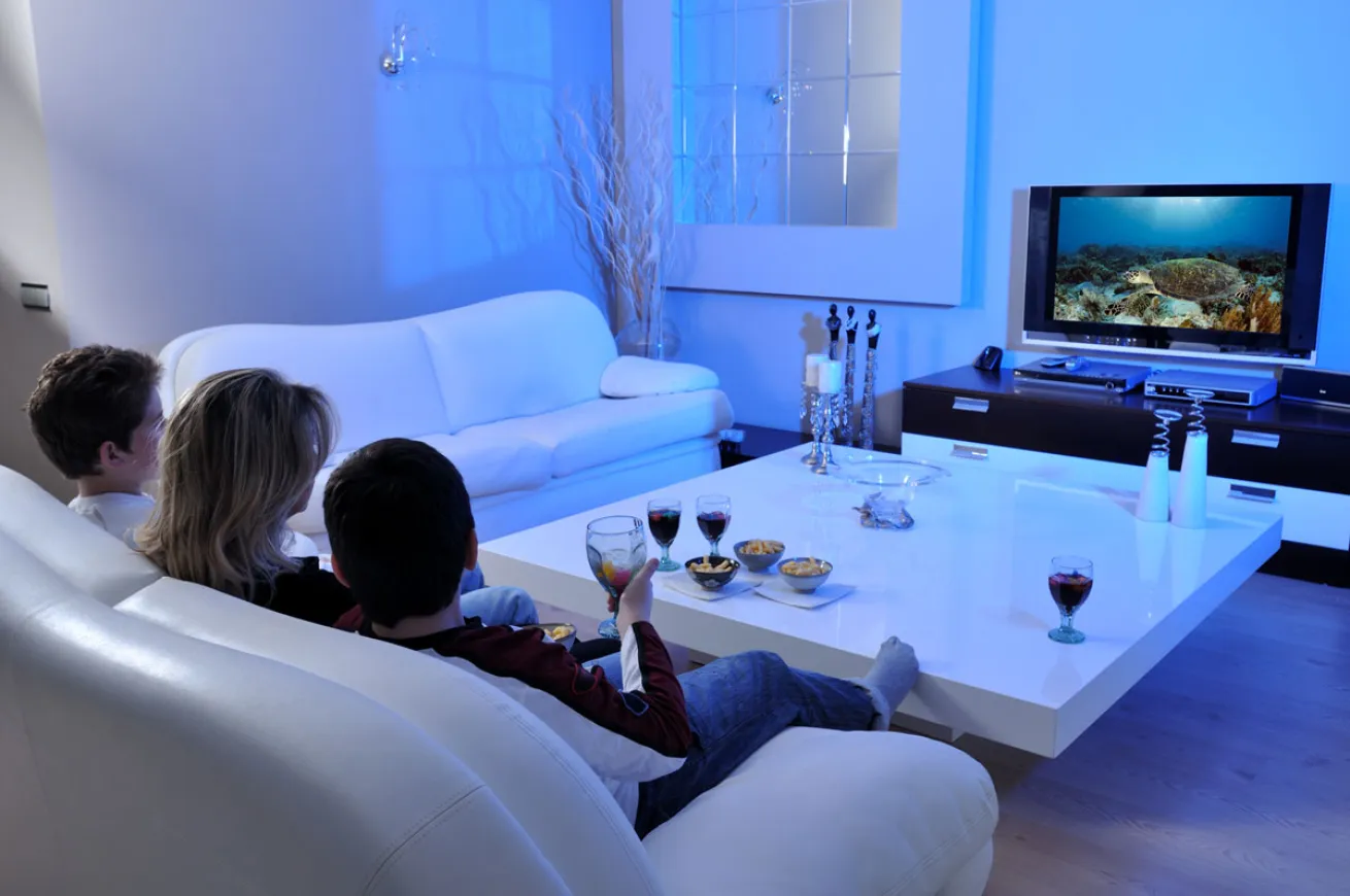 Family Watching Ocean Movie on Couch