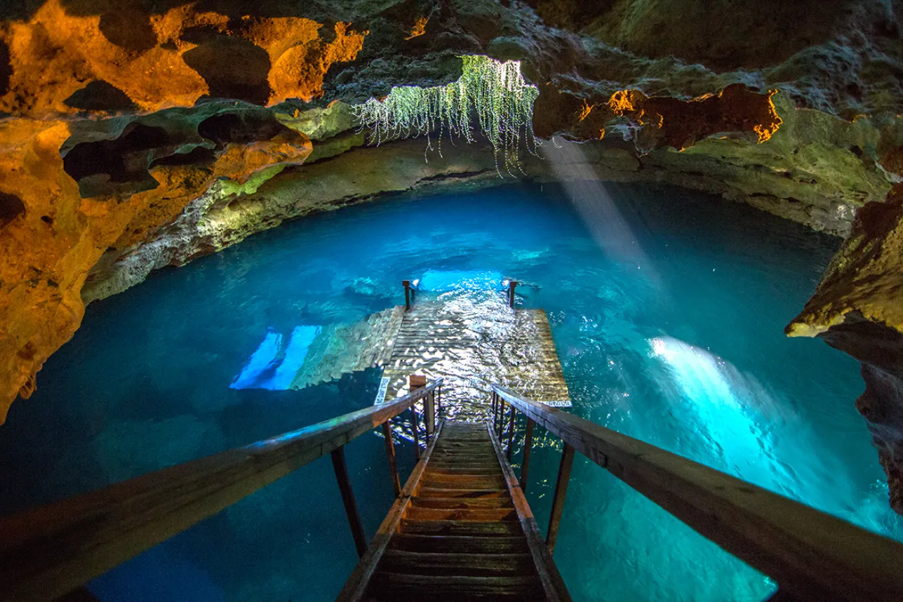 The stairs of Devil's Den leads to the spring, light by passthroughs from above.