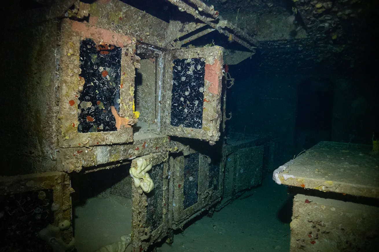 The galley of the USS Spiegel Grove partially light by a diver's light.