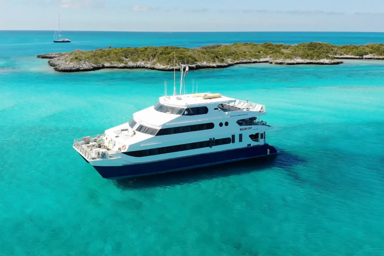 A large boat on the water by and island