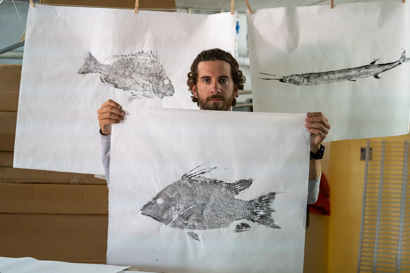Gyotaku artist with prints