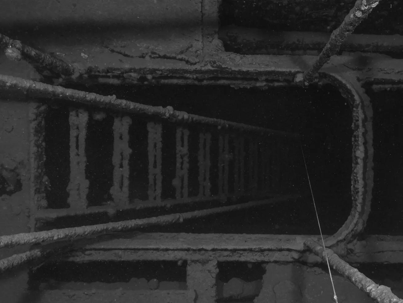 Stairs in the sunken ship Tokai Maru leading into darkness.