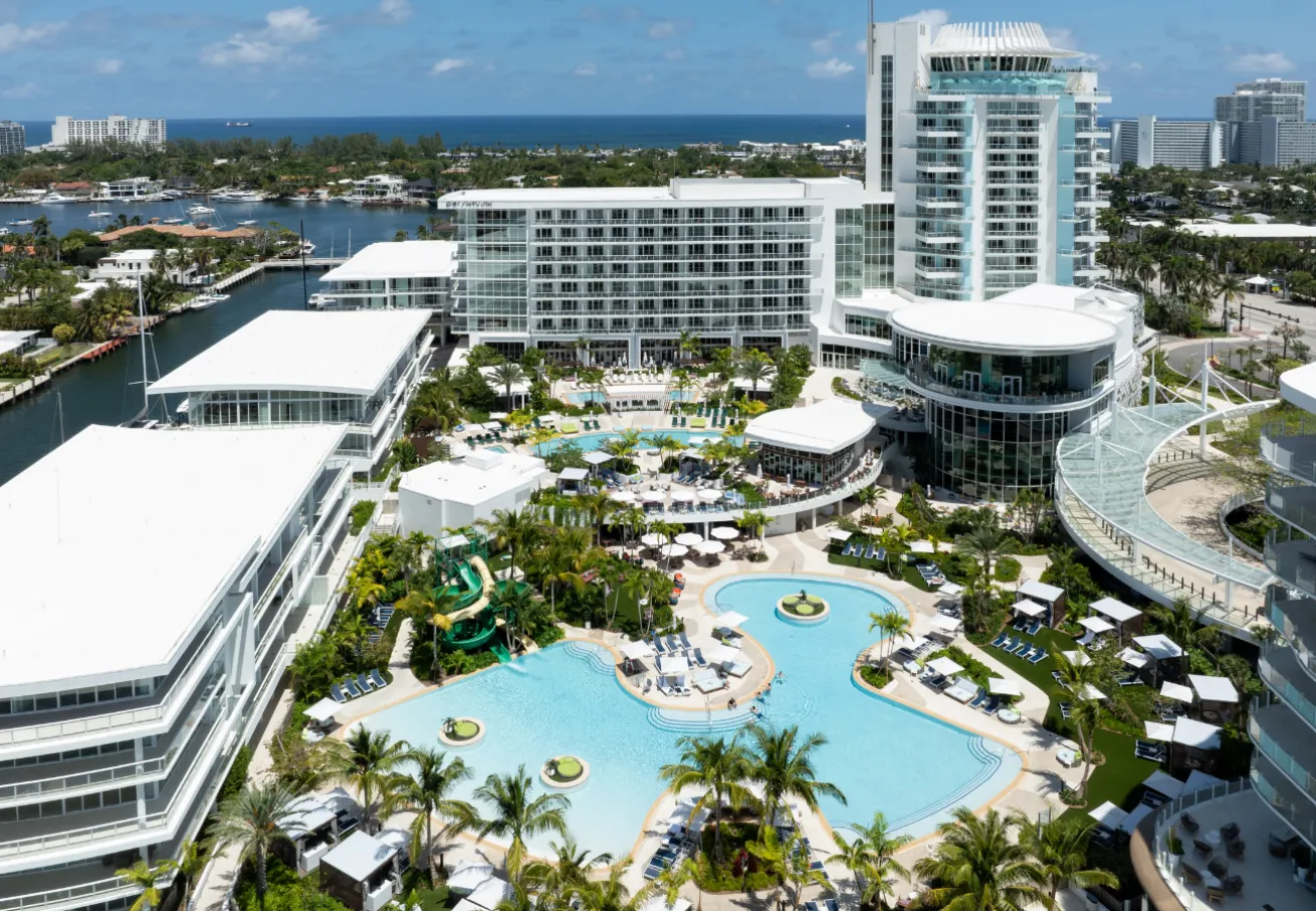 A large development with a pool and a body of water