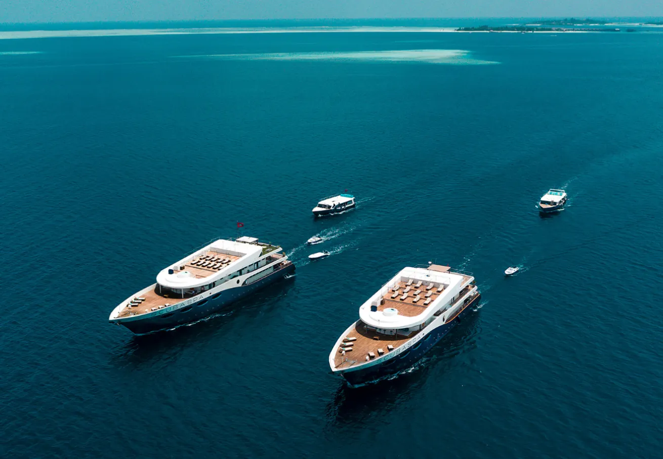 Scubaspa Yin and Yacht yachts with their respective Dhoni in the water – Maldives 