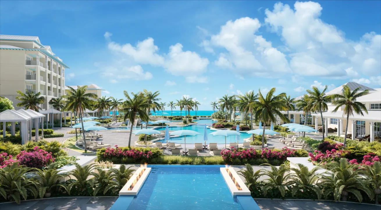 A pool with palm trees and a beach at the Beaches Treasure Beach Village in Turks and Caicos