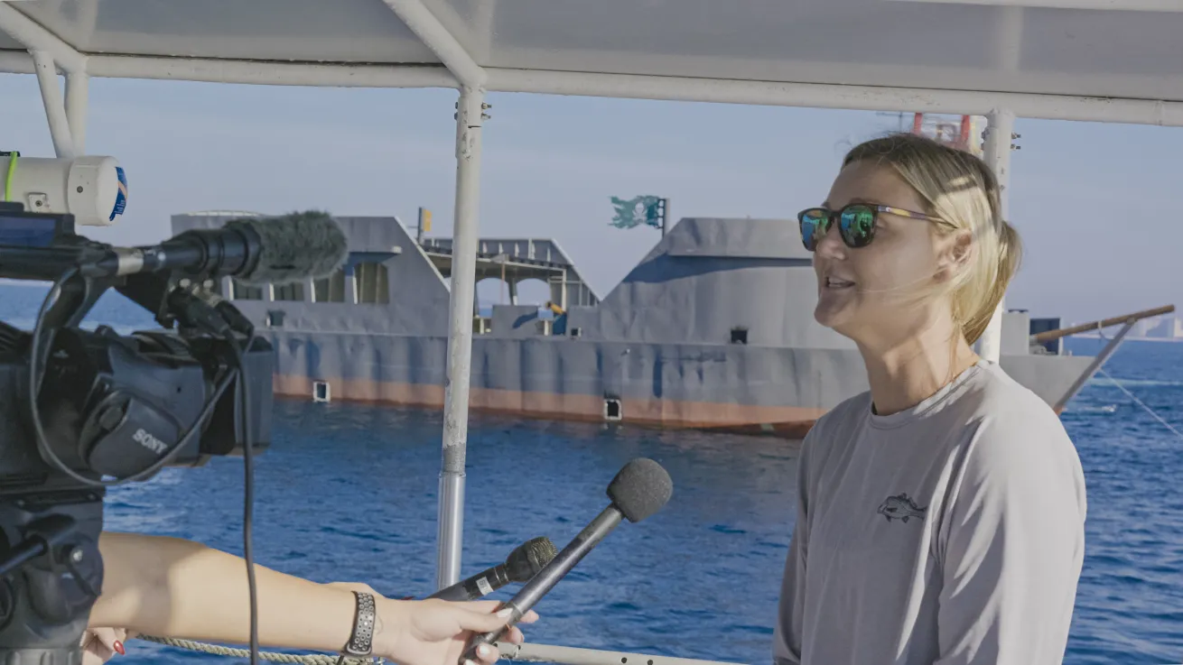 Erin Council Graham, Artificial Reef Coordinator and Coastal Resources Manager at Visit Panama City Beach, discusses the project with media crews. 