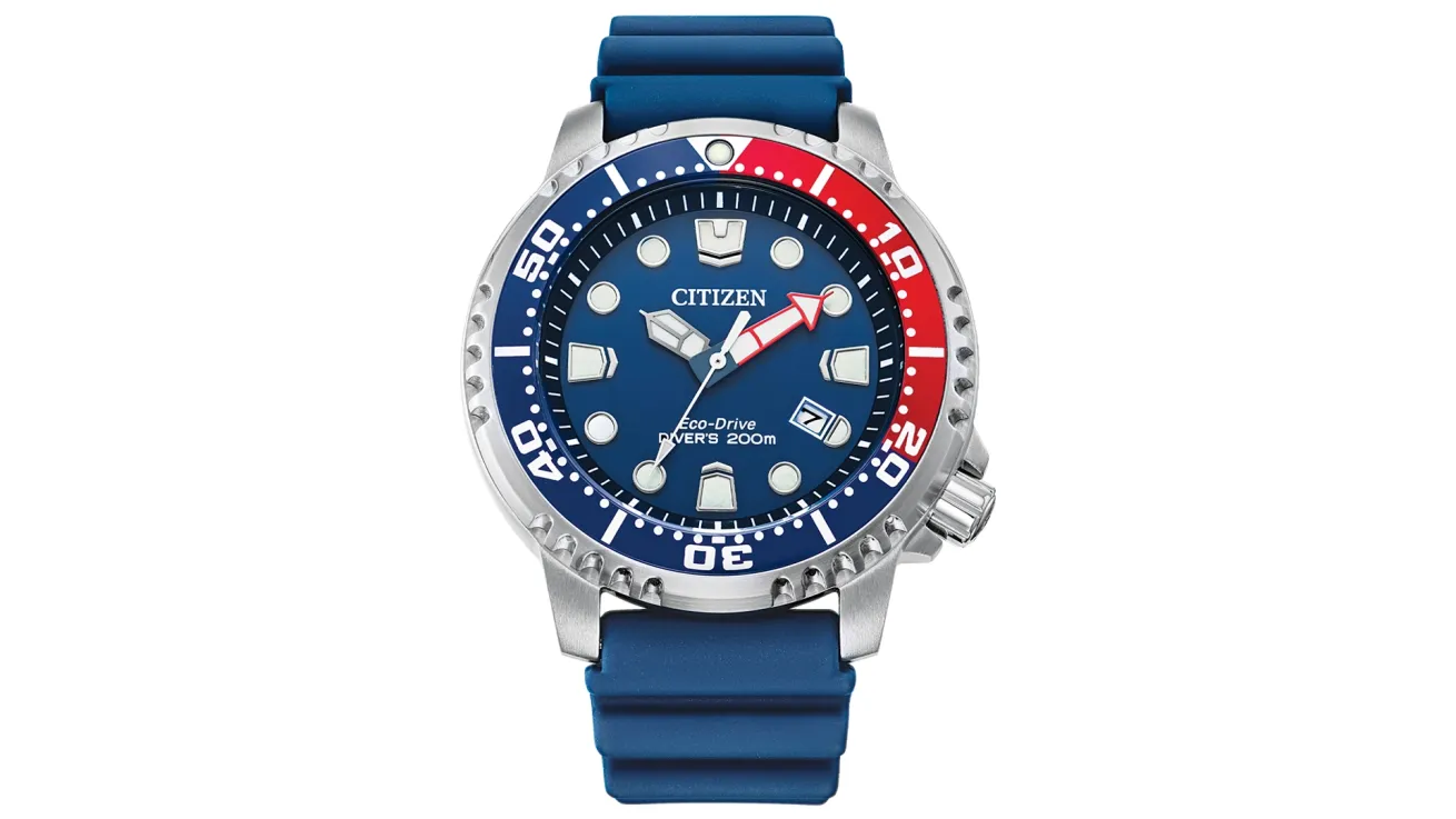 Citizen wristwatch, featuring a blue dial with white hour markers and hands, a date window, and a red and blue rotating bezel. The watch has a stainless steel case and a blue rubber strap, indicating water resistance up to 300 meters.