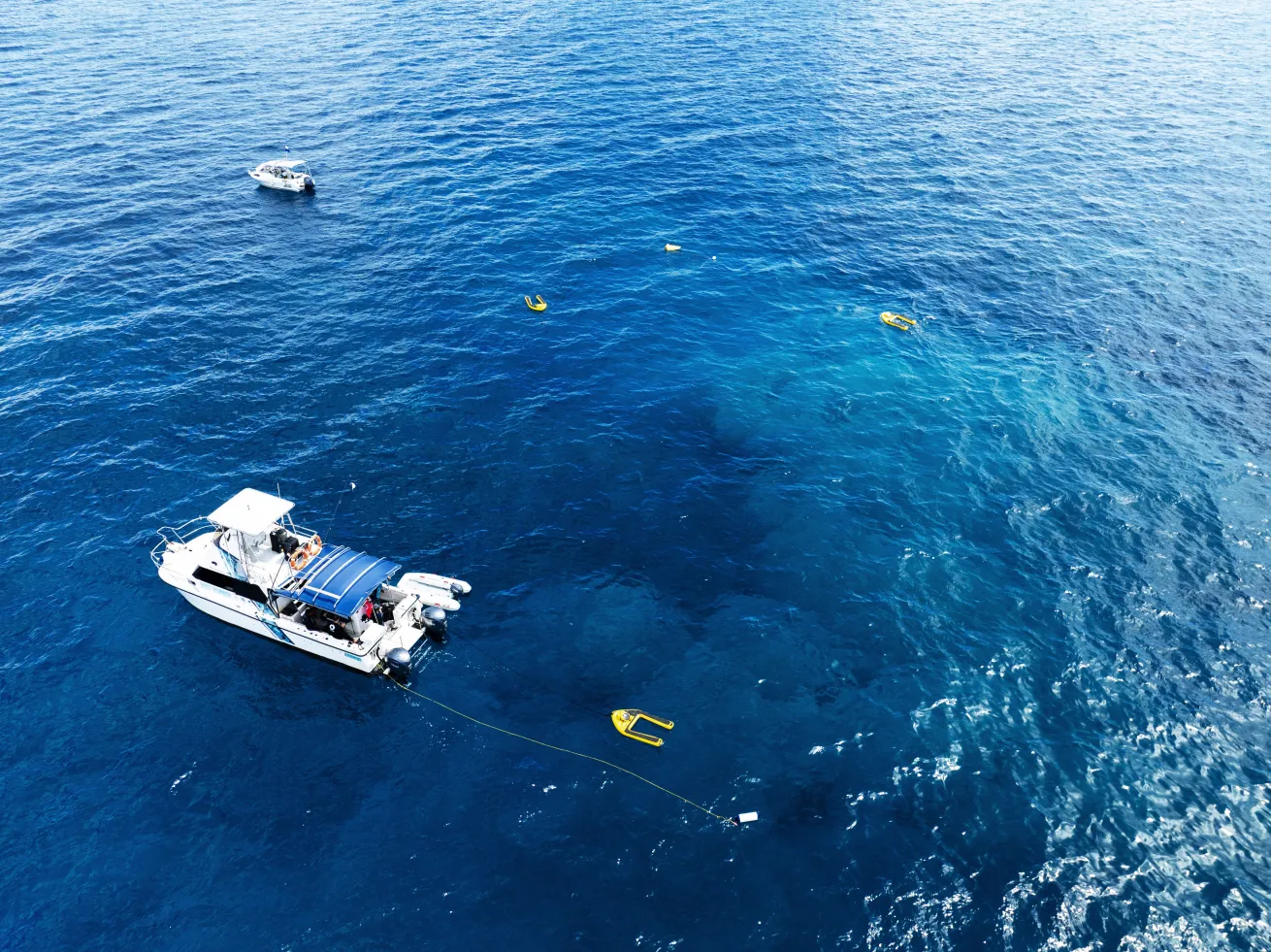 Aerial photo of unmanned surface vehicles and two support vessels in the Great Barrier Reef