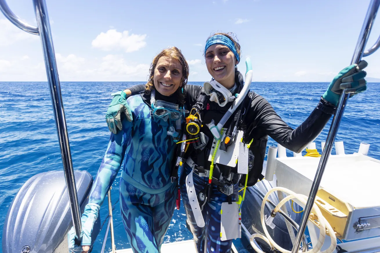 Two women, a mother and daughter, smile in dive gear after finding a record-breaking coral colony on the Great Barrier Reef