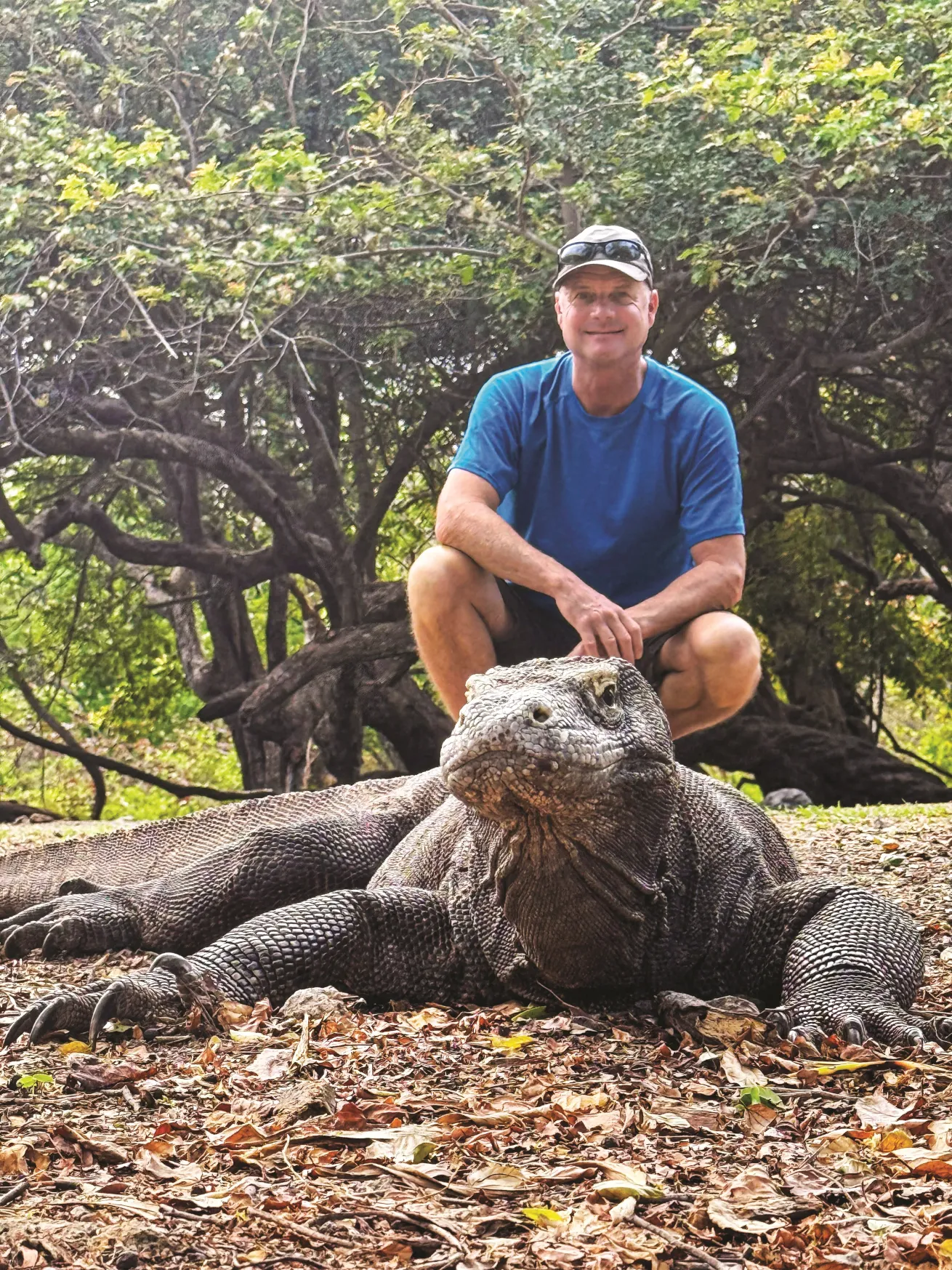 A park ranger’s photo of fellow Aggressor guest Jon posing behind a Komodo dragon.