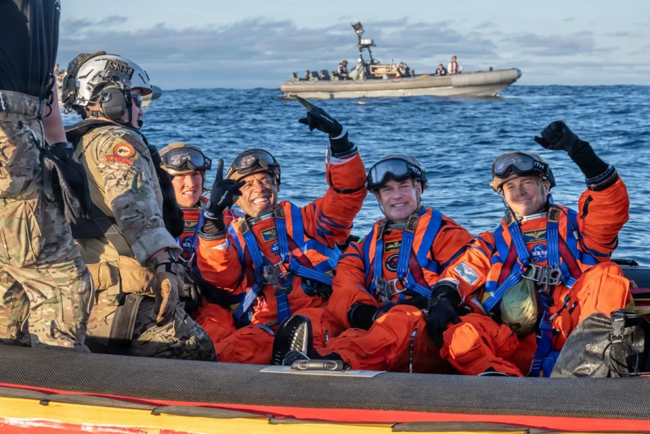From left to right, NASA astronauts Christina Koch and Victor Glover, Canadian Space Agency astronaut Jeremy Hansen, and NASA astronaut Reid Wiseman pose for a photo on the “front porch” before transiting to an amphibious transport dock ship.