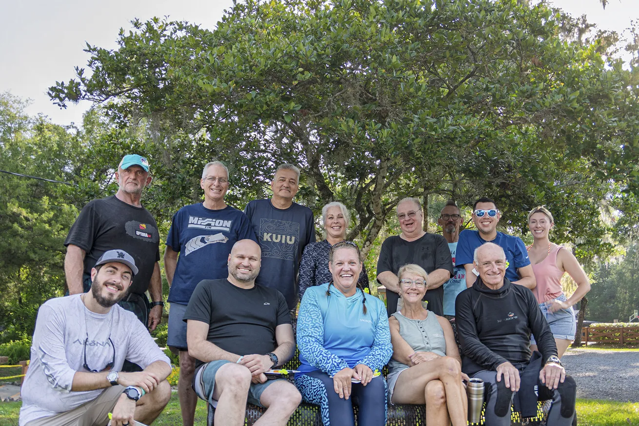 test divers posing in a group at blue grotto 