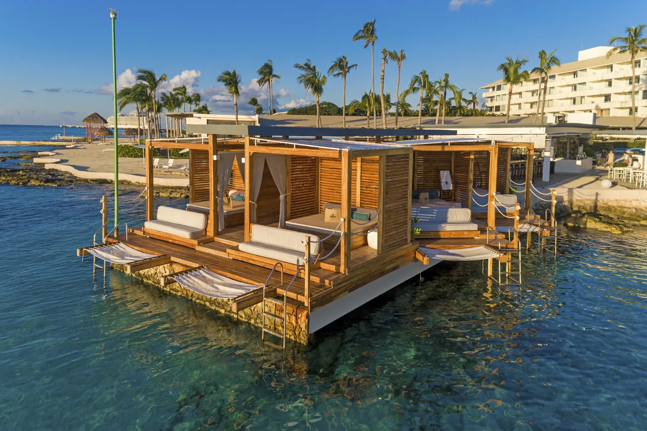 Private cabanas feature overwater hammocks.