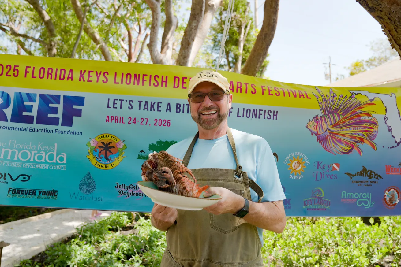 Participant of The Florida Keys Lionfish Derby & Festival holding a plate of Lionfish.