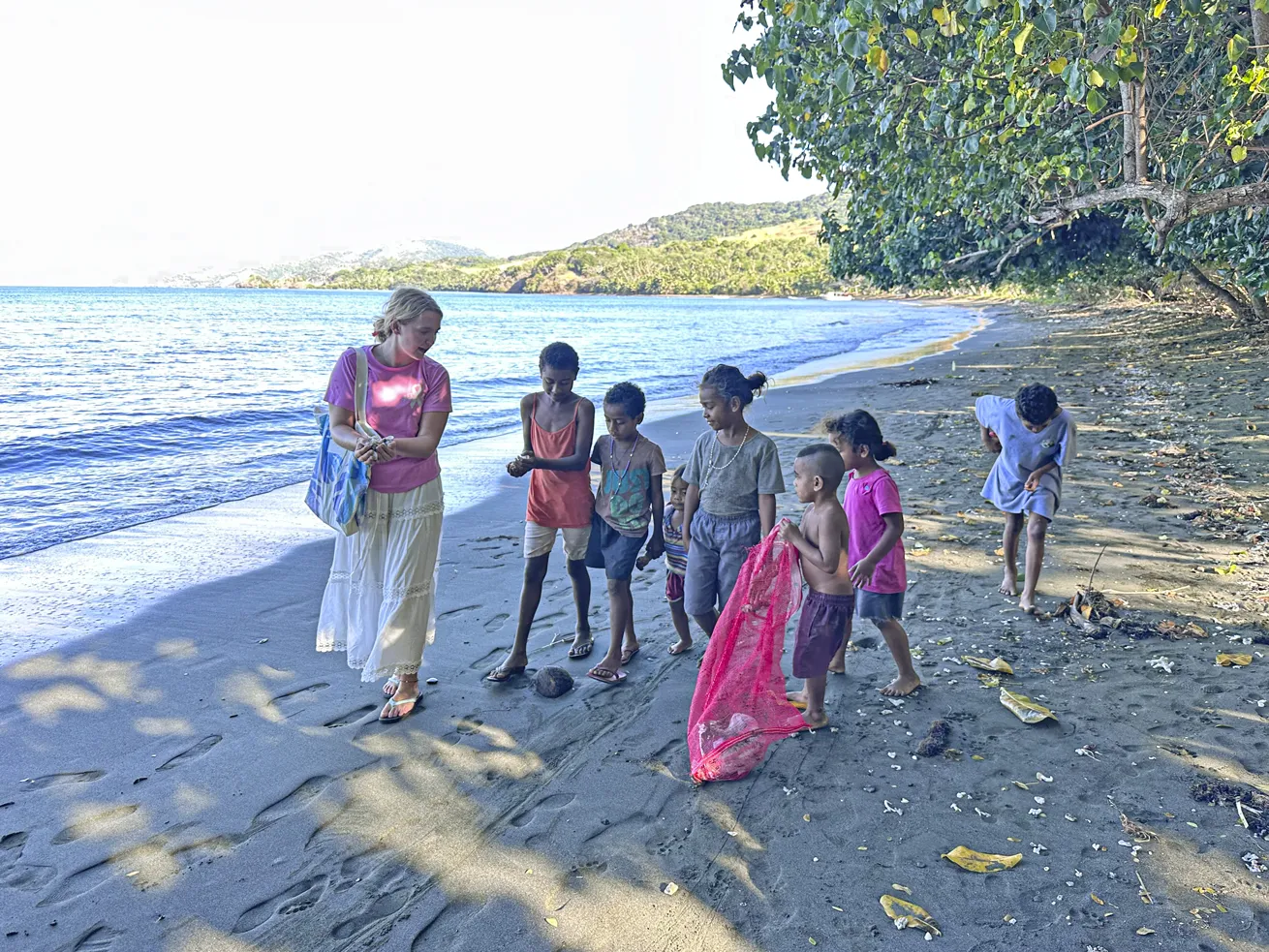 Maddy participates in a beach cleanup with local kids.