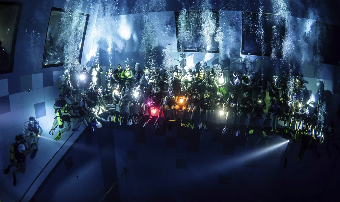 Deepspot, an indoor dive center in Poland, turns out the lights for a night-dive experience.