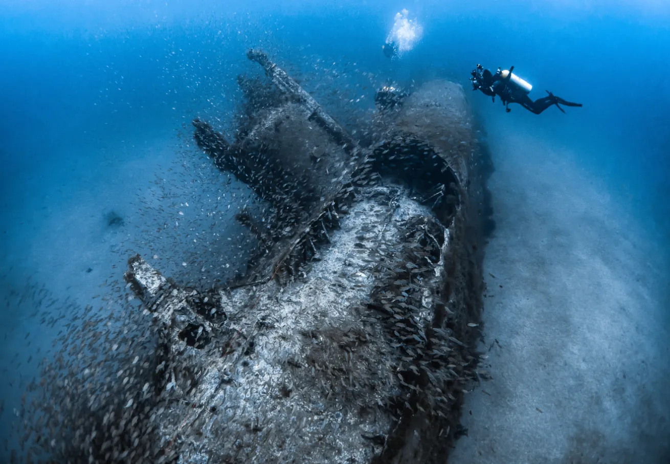 scuba diver on the wreck of the German submarine U-352