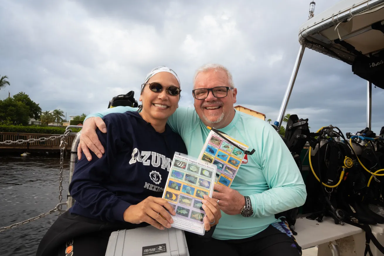 Divers holding up REEF Fish Survey templates in The Florida Keys during REEF Fest.