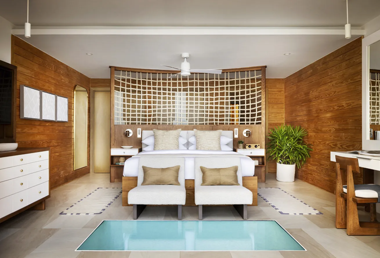 The lush bedroom in the Vincy Overwater Villa