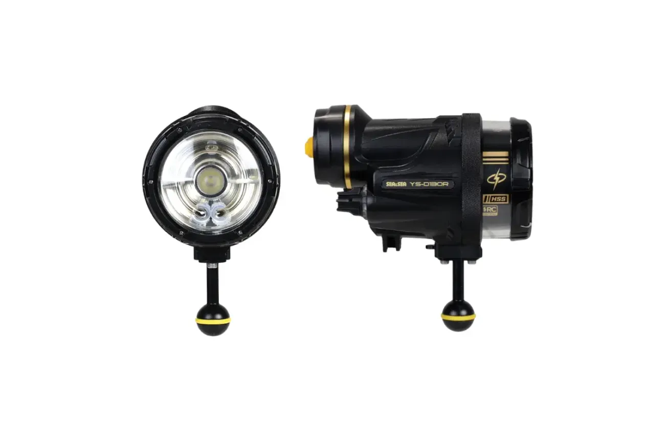 Compact black underwater strobe light with circular flash head and mounting arm, designed for photography lighting with even beam output and dual power options.
