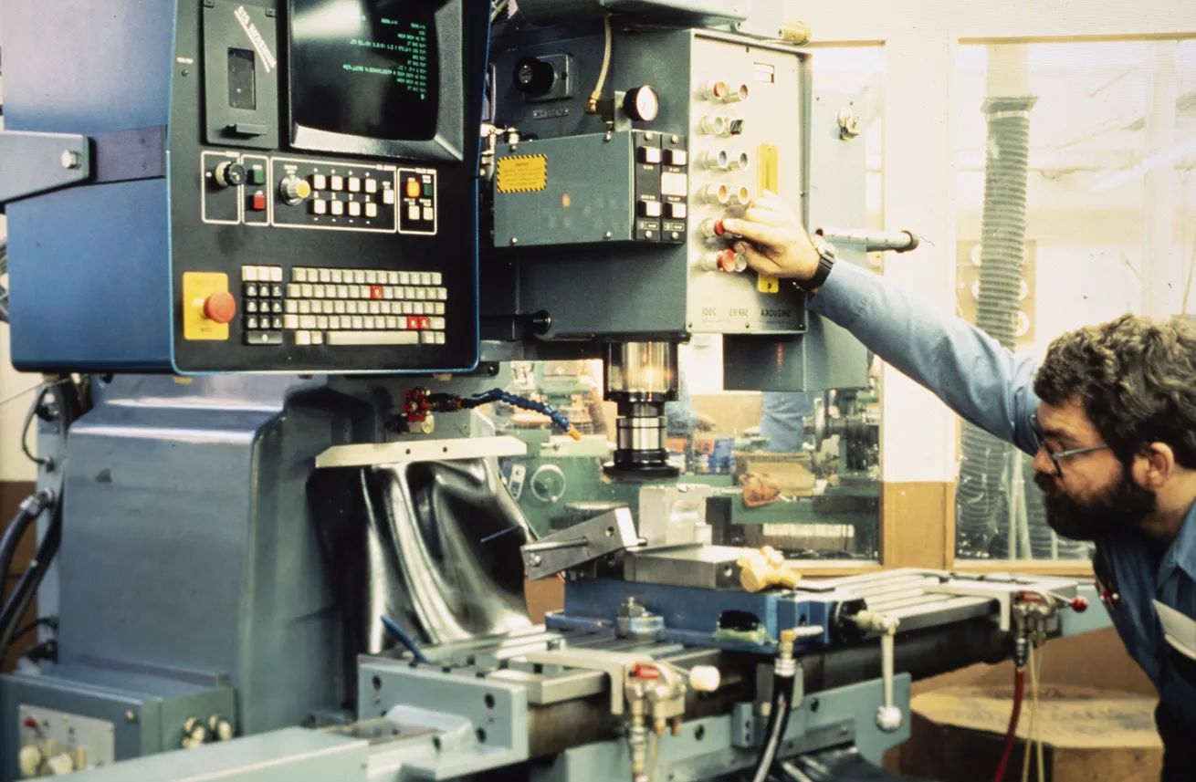 A machinist works on manufacturing Sherwood valves in the early 1980s.