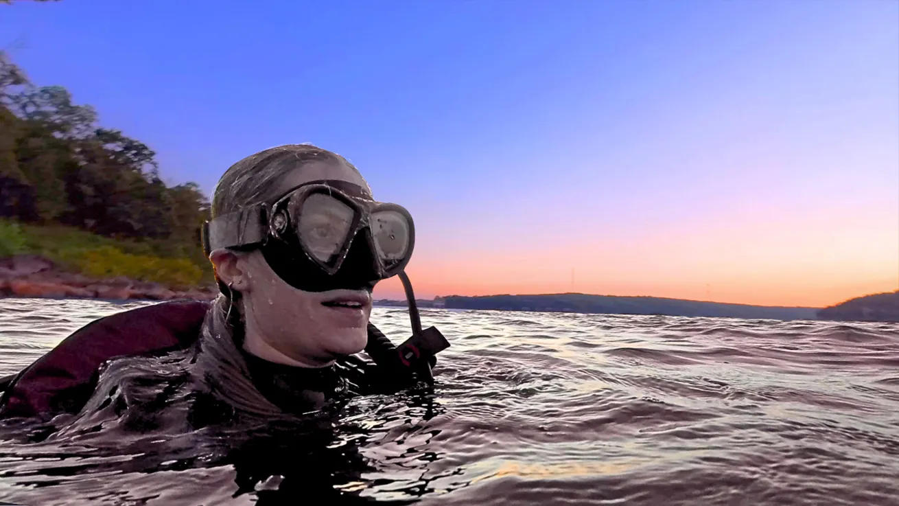 Olivia, the creator behind the Fully Submerged YouTube channel, on Lake Tenkiller’s surface.
