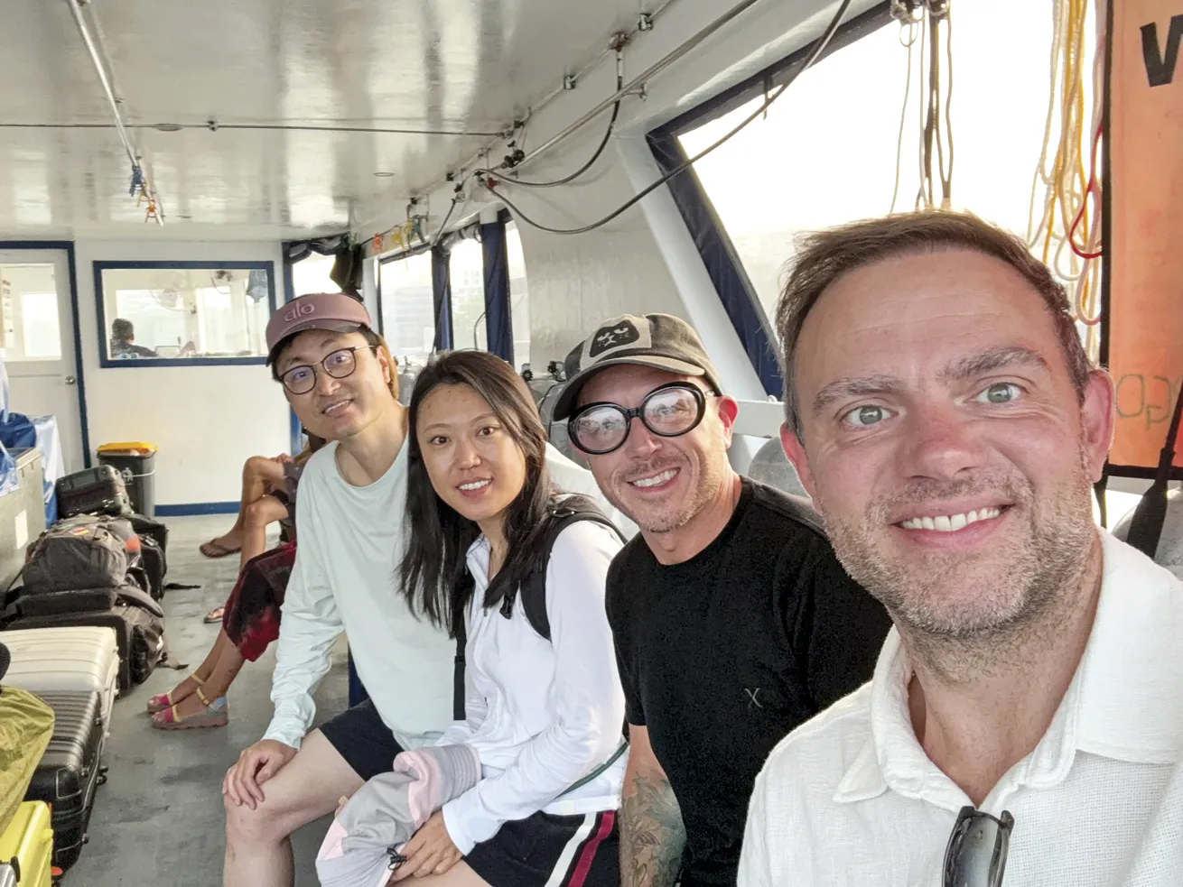 The author (second from right) and his dive group embark on a final dhoni ride after a memorable 10-day voyage.