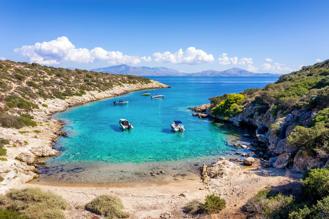 A small beach on the little island of Fleves, close to Athens, with turquoise sea and people enjoying the sun, Greece