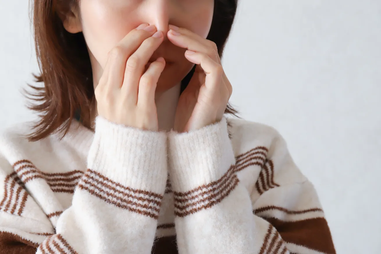 a woman holding her nose