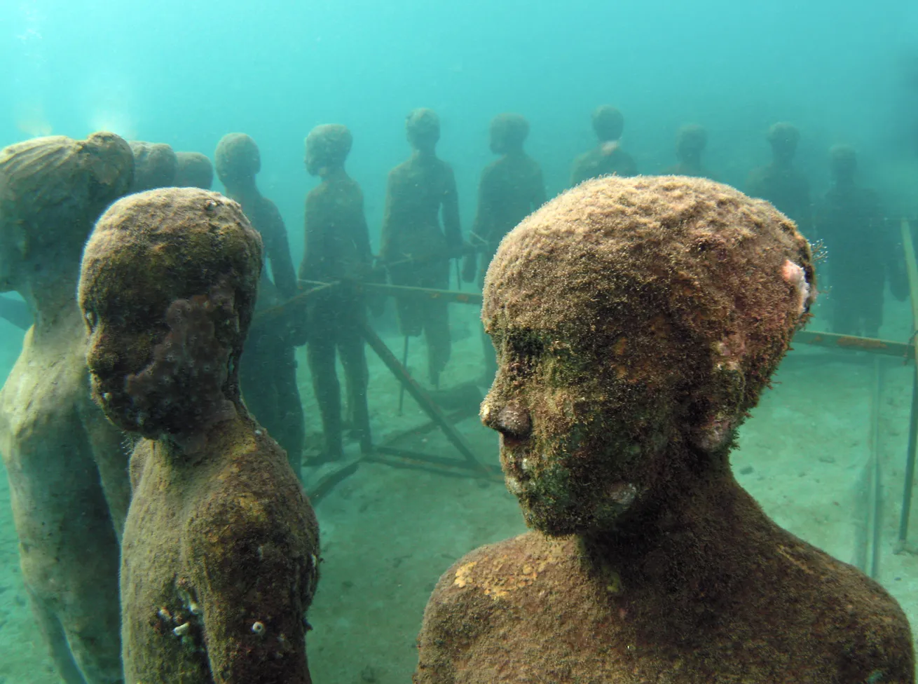 Submerged statues in Jason deCaires Taylor’s underwater art gallery, Molinere Bay Underwater Sculpture Park.