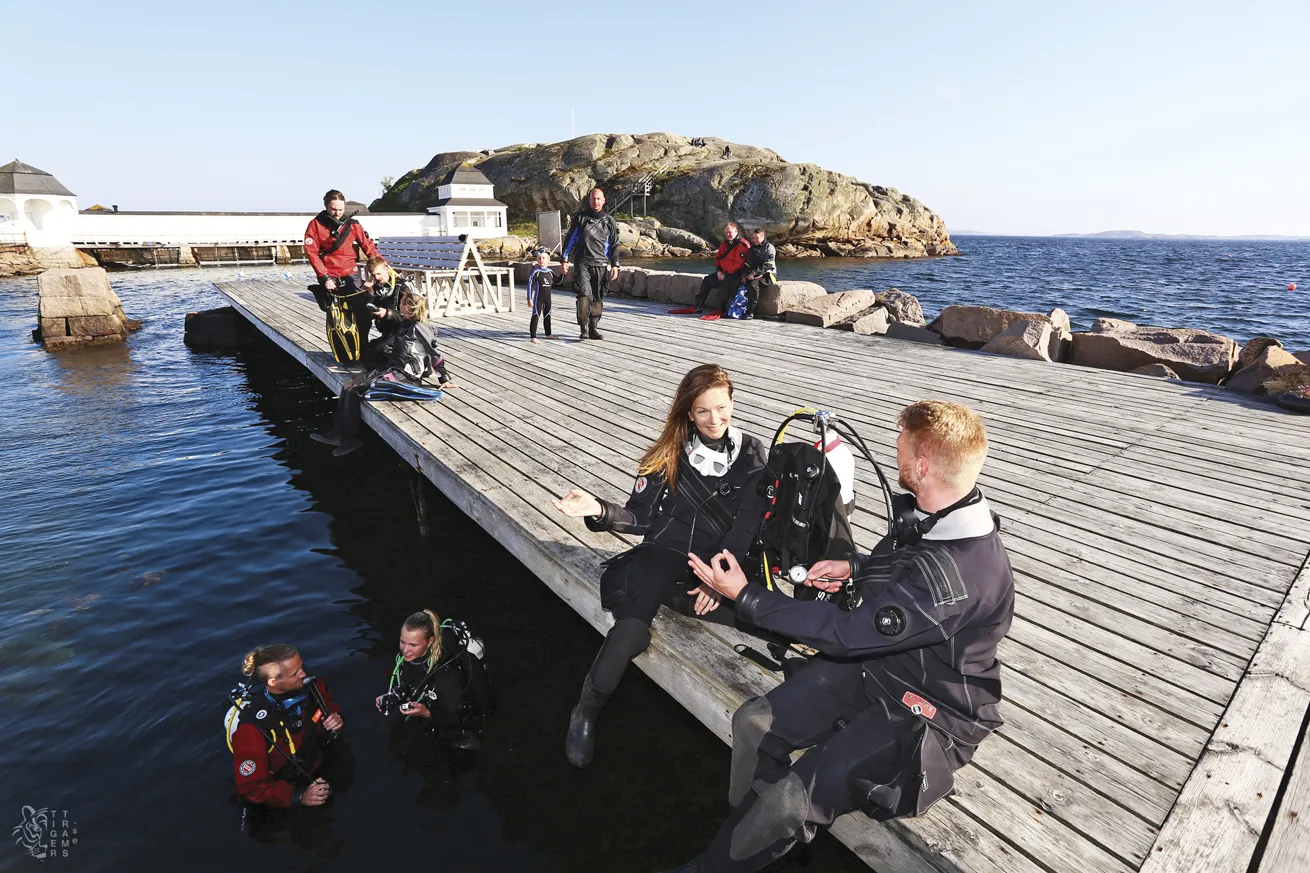 Donning drysuits to combat the chilly water temps, divers meet predive at a pier in Lysekil.