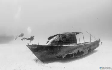 cuban-refugee-boat-w-divers.jpg.webp