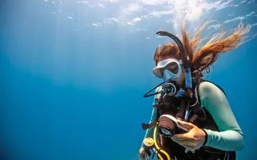 descending-diver-checks-gauges.png.webp