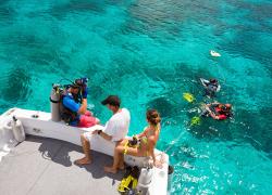 scuba divers entering the water