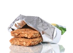Partially unwrapped granola bars on a white background